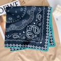 Detail of navy blue paisley silk scarf with contrast green edges on khaki shirt - Blue