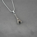 Colgante Torre Eiffel de acero inoxidable con textura marrón sobre tela gris - Colgante + Cadena a Juego