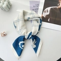 Close-up of blue and white square scarf with floral print tied in a stylish knot - 68x68cm / Blue