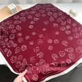 Macro detail of dark red rose print silk scarf with white border in lifestyle setting - Burgundy