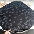 Detail showing retro herringbone square scarf with white rose patterns and border - Black