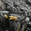 Vintage dragon head cable bracelet in black and gold with red eye accents on dark rock - Dragon Head Open Design / Black Gold Red Eyes