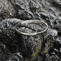 Minimalist silver titanium steel bangle with polished mirror finish on stone background - Bright Small Style / Steel