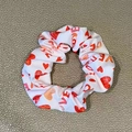 Detail of white satin scrunchie with red heart prints and LOVE text on grey surface - White Love Heart (5)