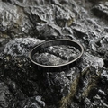 Minimalist black matte titanium steel oval bangle with mechanical hinge on volcanic rock - Shiny Black (Small)