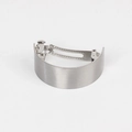 Detail of silver brushed metal hair clip showing the curved shape and spring mechanism - Medium / Silver