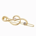 Fermaglio per capelli a nota musicale dorata con perla e strass su sfondo bianco - Oro