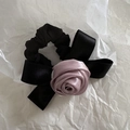 Detail of elegant satin rose flower and black bow on a vintage scrunchie hair accessory - Dusty Pink
