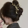 Golden bow-shaped metal hair claw clip for elegant updo hairstyles on model - Gold (Metal)