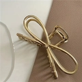 Detail of elegant gold metal bow hair claw clip with a glossy mirror finish on leather - Bow Style B-1 / Gold