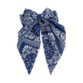 Close-up of dark blue paisley print bow hair clip with vintage bohemian flowing ribbons - Spring Clip Style / Navy Blue