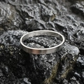 Minimalist silver steel oval bangle with premium brushed matte finish on dark stone - Brushed Steel Tone (Small)