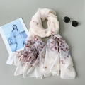 Elegant light blue floral silk scarf for women displayed with fashion magazine and sunglasses - Floral Style / Off White