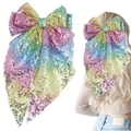 Detailed macro view of large rainbow sequin bow hair clip with long streamers on hair - Mermaid Color