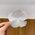 Floral claw clip with aurora pearl finish and iridescent shell texture in white - White