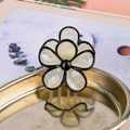 Translucent cream white flower hair claw clip with black outlines in a gold tray - White