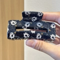 Detail of black Halloween shark hair clip with white ghost and orange candy patterns - Black Ghost Candy Pattern