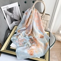 Detail of floral silk square scarf in light blue with orange flower patterns on a frame - Light Blue / 70*70cm