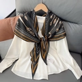 Detail showing elegant white shirt with paisley printed neck scarf on a cozy sofa - 170x50cm / Black