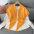 Orange diamond silk scarf with chain print styled on a white shirt hanger display - 170x50cm / Orange