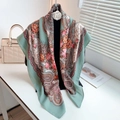 Detail of mint green paisley scarf with floral patterns on a display stand - Herringbone Large Square Scarf / Cyan Blue