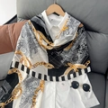 Chic chain print cotton linen scarf with baroque patterns draped over a white shirt - Black