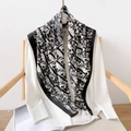 Elegant black and white silk scarf with abstract patterns draped on a wooden chair - 90x90cm / Black