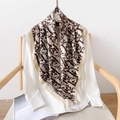Elegant silk scarf with brown graffiti print on white background draped over a chair - 90x90cm / Off White