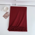 Detail view of burgundy soft pashmina scarf with elegant fringes on a white surface - 185x70cm / Dark Red