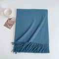 Detail of blue faux cashmere scarf showing soft texture and fringe tassels on a white background - 185x70cm / Aqua