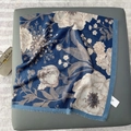 Detail view of floral print silk scarf with frayed edges in elegant deep blue color - 130x130cm / Royal Blue