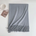 Detail of grey cashmere-like winter scarf with soft fringed edges and cozy knit texture - 185x70cm / Light Gray