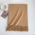 Detailed view of camel cashmere scarf texture with long fringe tassels on white surface - 185x70cm / Raw Yellow