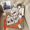Classic white and orange silk scarf with retro carriage print tied on a handbag - Orange