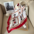 Chic silk scarf with vintage carriage print draped over a premium leather handbag - Red