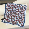 Close-up of blue tulip patterned silk scarf with broad borders and a brand tag - Blue