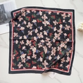 Detailed view of square silk scarf with floral pattern on marble background - Black Red White Floral (58FJ95-2)