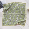Detailed flat lay of silk-like green square scarf with white floral print on marble - Grass Green White Floral (58FJ88-4)