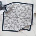 Detail of square silk scarf with black and white floral prints on marble background - White Black Border Floral (58FJ90-4)