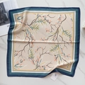 Detailed view of square faux silk scarf with orange floral prints and colorful borders - Beige Orange Flower Clusters (58FJ91-3)
