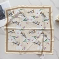 Detail view of satin square scarf with purple tulip floral print on marble background - Purple Tulip Patchwork (58FJ92-4)