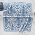 Close-up of a 58cm silk-feel square scarf with blue baroque patterns on smooth satin fabric - Light Blue White Baroque (58FJ93-2)