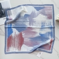 Detailed close-up of a 58cm square silk scarf with blue abstract floral patterns on marble - Blue Purple Red Abstract (58FJ89-3)