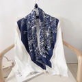 Elegant 90cm blue and white floral silk scarf styled with a white shirt on a chair - 90x90cm / Dark Blue
