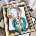 Silk-feel square scarf with vibrant orange and blue floral print tied on a decorative frame - 70cmx70cm / Blue