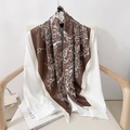 Brown printed silk scarf with cream borders and bird patterns draped on white shirt - 90x90cm / Coffee