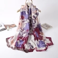 Elegant floral silk scarf with oil painting patterns hanging on a wooden hanger - Purple