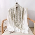 Elegant white silk shirt paired with an olive green geometric pattern scarf on a chair - 90*90cm / Off White