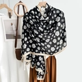 Elegant black camellia flower scarf draped over wooden hanger in a lifestyle setting - Rectangle / Black