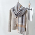 British style plaid scarf in grey and orange shades with tassels on a tweed coat - Deep Purple